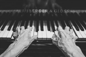 Hands of an older person playing the piano