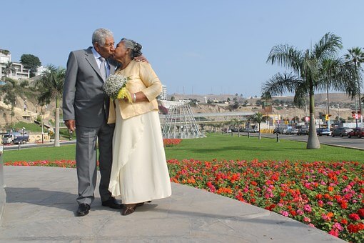 mature couple, walking in park, kissing